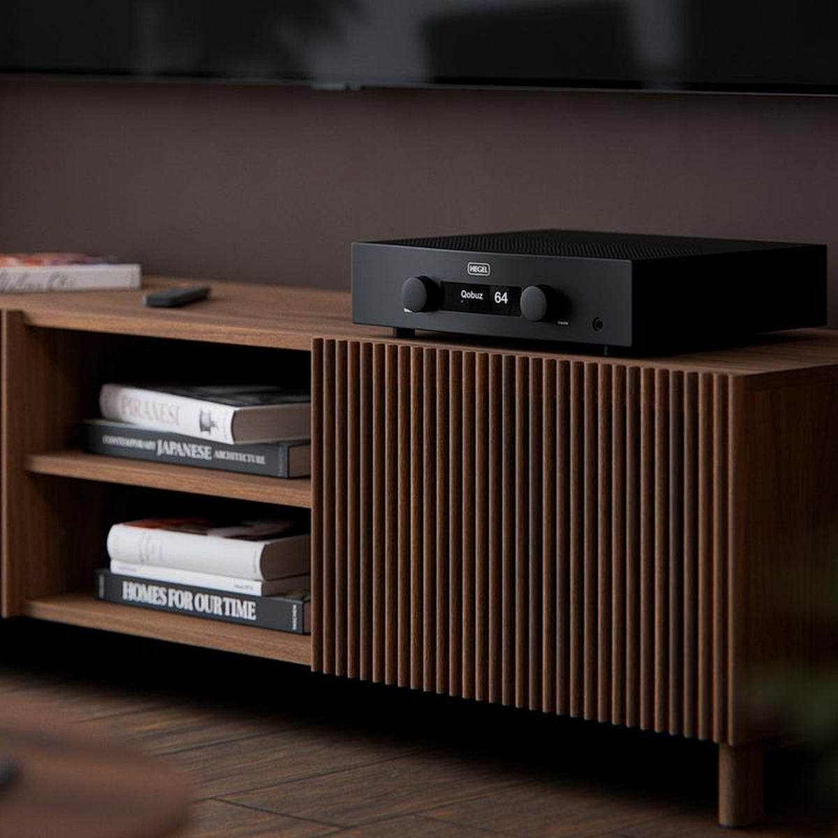Hegel H200 integrated amplifier on a walnut sideboard in a living room