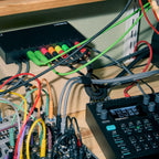Elektron Outbox 8 sending CV to a modular rack on a studio shelf